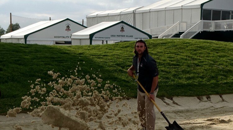 US Open Volunteer Shovels Sand